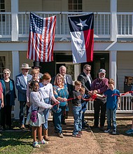 Anderson Mayor Marc Benton, center, helps cut the ribbon on Fanthorp Inn State Historic Site on Friday, Nov. 15, in Anderson. (Patrick Hughey | Texas Historical Commission)
