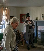 Fanthorp Inn State Historic Site Educator/Interpreter Chandler Wahrmund, right, directs a guest at the site on Friday, Nov. 15. The site reopened following an extensive restoration project. (Patrick Hughey | Texas Historical Commission)