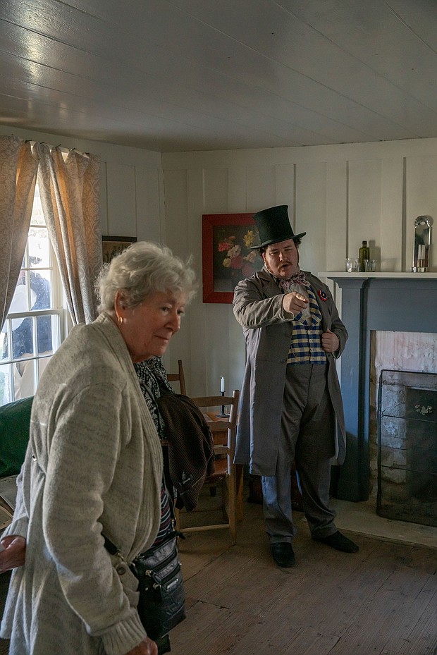 Fanthorp Inn State Historic Site Educator/Interpreter Chandler Wahrmund, right, directs a guest at the site on Friday, Nov. 15. The site reopened following an extensive restoration project. (Patrick Hughey | Texas Historical Commission)