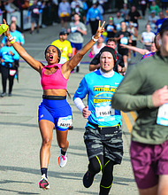 Enuma Iyob celebrates Saturday, Nov. 16, as she crosses the finish line of the CarMax Richmond Half Marathon.