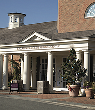 Christmas decorations adorn the front of the E. Claiborne Robins Visitor Center, where guests of Lewis Ginter Botanical Garden can purchase tickets.