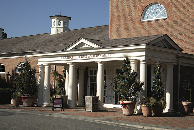 Christmas decorations adorn the front of the E. Claiborne Robins Visitor Center, where guests of Lewis Ginter Botanical Garden can purchase tickets.