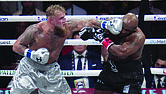 Jake Paul lands a left on Mike Tyson during their heavyweight boxing match, Friday, Nov. 15, in Arlington, Texas.