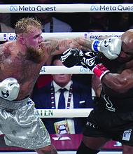 Jake Paul lands a left on Mike Tyson during their heavyweight boxing match, Friday, Nov. 15, in Arlington, Texas.