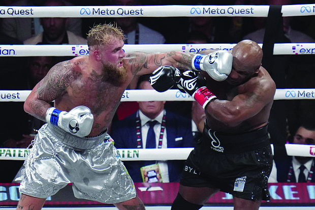 Jake Paul lands a left on Mike Tyson during their heavyweight boxing match, Friday, Nov. 15, in Arlington, Texas.