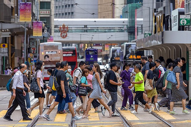Pedestrians cross a street in Hong Kong on June 25.
Mandatory Credit:	Paul Yeung/Bloomberg/Getty Images via CNN Newsource