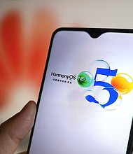 Huawei's HarmonyOS NEXT operating system is displayed on a smartphone screen with a Huawei logo in the background.
Mandatory Credit:	VCG/Getty Images via CNN Newsource