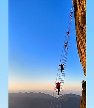 Travelers climbing the "sky ladder."
Mandatory Credit:	Courtesy Qixing Adventure via CNN Newsource