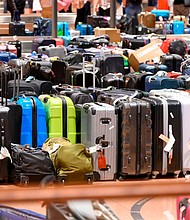 Hundred of suitcases, bags and baby carriages are stacked up at Hamburg Airport in Germany.
Mandatory Credit:	Jonas Walzberg/picture-alliance/dpa/AP via CNN Newsource