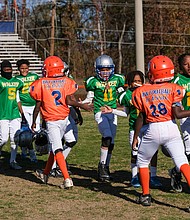 Players at a recent Armstrong Walker Football Classic congratulate each other after a recent game.