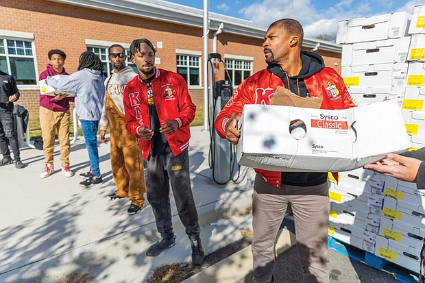 Volunteers from the Kappa Alpha Psi Richmond Alumni Chapter distribute turkeys during the 6th Annual Thanksgiving Turkey Giveaway and Resource Fair at River City Middle School, 6300 Hull Street Rd., on Saturday, Nov. 23. Del. Mike Jones (77th District), supported by Rosie’s Richmond and Churchill Downs Incorporated, provided 2,000 turkeys to Richmond residents.