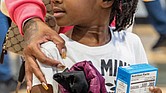 Maleah Harris, 4, carries a box of cornbread mix during the 6th Annual Thanksgiving Turkey Giveaway and Resource Fair on Nov. 23 at River City Middle School, 6300 Hull Street Road.
State Delegate Mike Jones, alongside leaders from Rosie’s and Churchill Downs, distributed 2,000 turkeys to Richmond residents, while Virginia Sen. Ghazala Hashmi and her team handed out over a thousand boxes of cornbread mix.