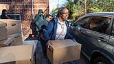 Rose Bolling helps distribute Thanksgiving meals at Trinity Baptist Church in Richmond’s North Side on Saturday, Nov. 23. Meals were handed out curbside behind the church. Along with boxes of groceries for a Thanksgiving meal, recipients received gift cards to purchase a turkey or other items of their choice.