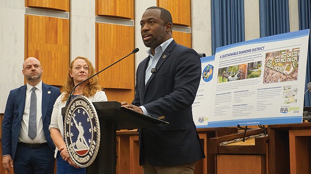 From left, Institute for Sustainable Infrastructure President and CEO Anthony Kane and Office of Sustainability Director Laura Thomas look on as Mayor Levar M. Stoney shares updates on the city’s RVA Green 2050 plan Friday at City Hall.