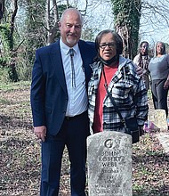 Latter-day Saints Church Branch President Kerry Petersen and Margaret “Tina” Webb stand at the tomb of her grandfather, WWII veteran John Robert Webb, with relatives Shara Khon and Mary Duncan in the background at Dorothy E. Ball’s tombstone.