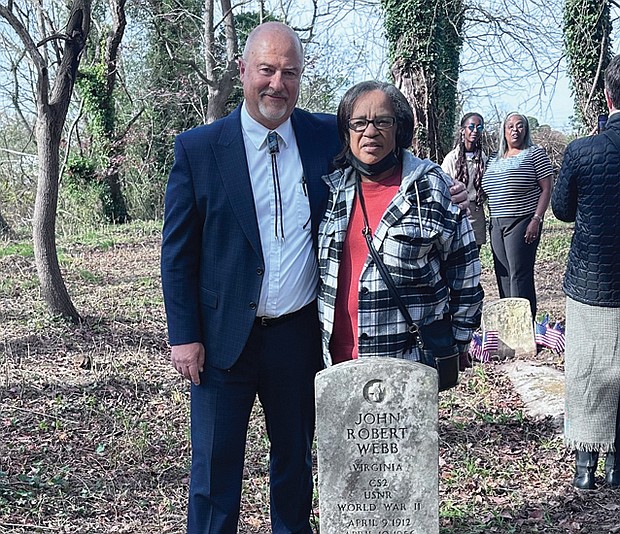 Latter-day Saints Church Branch President Kerry Petersen and Margaret “Tina” Webb stand at the tomb of her grandfather, WWII veteran John Robert Webb, with relatives Shara Khon and Mary Duncan in the background at Dorothy E. Ball’s tombstone.
