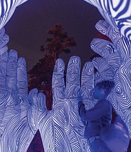 Scenes from 1708 Gallery’s annual InLight exhibition at Pine Camp Cultural Arts and Community Center, Friday, Nov. 8 - Jordan Ashe stands inside an illuminated artwork titled “Carry Us Home” by Monique Lorden.