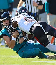 Azeez Al-Shaair lands a late hit on Jags quarterback Trevor Lawrence.
Mandatory Credit:	Tom DiPace/PACET via AP via CNN Newsource