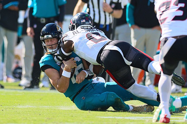 Azeez Al-Shaair lands a late hit on Jags quarterback Trevor Lawrence.
Mandatory Credit:	Tom DiPace/PACET via AP via CNN Newsource