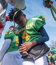 Mahki Grey of the Maggie L. Walker Dragons gets his medallion after the 12-0 win over Armstrong in the 4th Annual Armstrong Walker Classic Football game at Armstrong High School on Nov. 30.