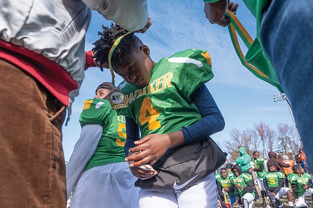 Mahki Grey of the Maggie L. Walker Dragons gets his medallion after the 12-0 win over Armstrong in the 4th Annual Armstrong Walker Classic Football game at Armstrong High School on Nov. 30.