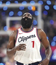 Los Angeles Clippers guard James Harden looks toward the scoreboard after making a three-point shot that put him at 2,998 points for three-point shots during the first half of a game against the Denver Nuggets, Sunday, Dec. 1.