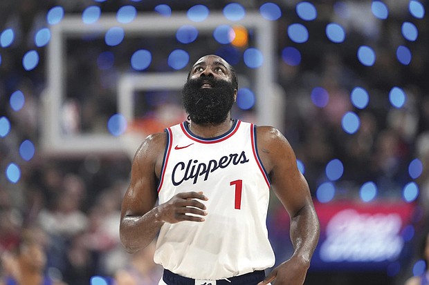 Los Angeles Clippers guard James Harden looks toward the scoreboard after making a three-point shot that put him at 2,998 points for three-point shots during the first half of a game against the Denver Nuggets, Sunday, Dec. 1.