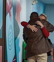Richmond Registrar Keith Balmer hugs a staff member at the Richmond Elections office after resigning during a closed-door session of the Richmond Electoral Board.