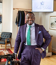 Andre’ McLaughlin, owner and designer of Andre’ Julius, stands in his Richmond showroom, where he provides custom suits and tuxedos through personalized, appointment-only sessions.