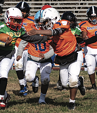 Jaeqwan Buck of the Maggie L. Walker Dragons charges forward during the team’s 12-0 victory over Armstrong at the Armstrong Walker Football Classic Legacy Project at Armstrong High School.