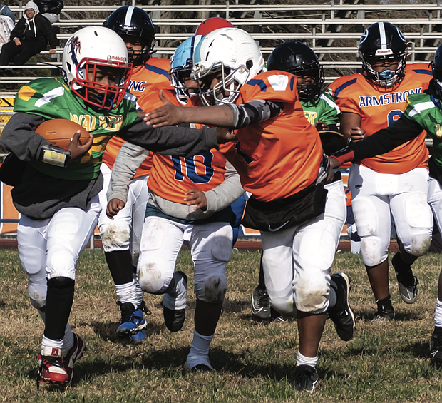 Jaeqwan Buck of the Maggie L. Walker Dragons charges forward during the team’s 12-0 victory over Armstrong at the Armstrong Walker Football Classic Legacy Project at Armstrong High School.