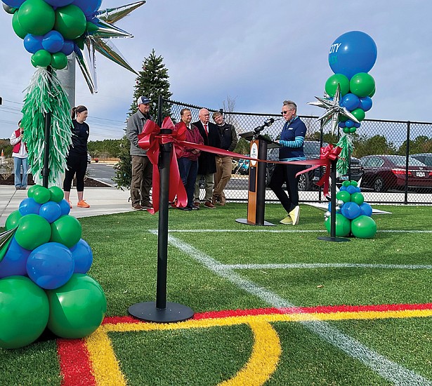 Jessica Schneider, Clover Hill District Supervisor, addresses the crowd at the ribbon-cutting ceremony for the four new lighted turf fields at River City Sportsplex.