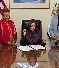 Vice President Kamala Harris, accompanied by U.S. Rep. Barbara Lee (D-CA) and U.S. Sen. Laphonza Butler (D-CA), signs the Shirley Chisholm Congressional Gold Medal Act at the U.S. Capitol on Monday, Dec. 9.