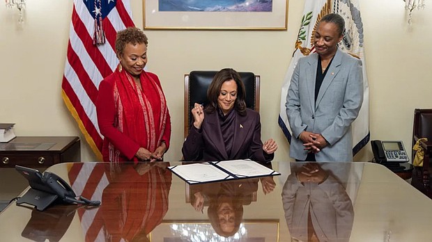 Vice President Kamala Harris, accompanied by U.S. Rep. Barbara Lee (D-CA) and U.S. Sen. Laphonza Butler (D-CA), signs the Shirley Chisholm Congressional Gold Medal Act at the U.S. Capitol on Monday, Dec. 9.