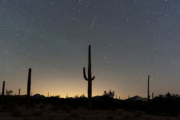 A meteor streaks through the night sky during the annual Geminid meteor shower in Lukeville, Arizona, in December 2023. The Geminids are expected to be most active between noon and 8 p.m. ET on December 13.
Mandatory Credit:	Go Nakamura/Reuters via CNN Newsource