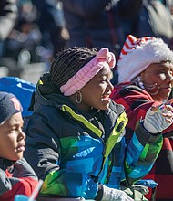 Bracela Wright, a 37-year parade veteran, watches alongside young Erina and Elijah.