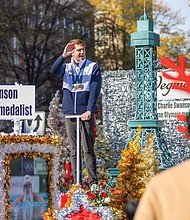 Charlie Swanson, an olympic medalist and the grand marshall of the parade, waves to watchers
on the sidewalks.
