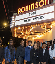 Thomas Jefferson High School staff and football players gather outside the Robinson Theater Community Arts Center for the 2024 Maxie Awards Banquet.