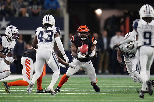 Cincinnati Bengals linebacker Maema Njongmeta recovers the key blocked punt in the win over the Cowboys.
Mandatory Credit:	Julio Cortez/AP via CNN Newsource