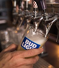 A bartender pours a Bud Light from a tap.
Mandatory Credit:	Drew Angerer/Getty Images/File via CNN Newsource