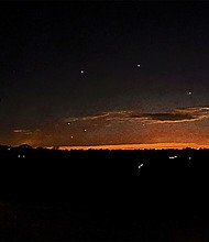 The evening sky and points of light are seen near Lebanon Township, New Jersey, on December 5. The sightings have put intense pressure on federal agencies to provide more information about the aircraft.
Mandatory Credit:	Trisha Bushey/AP via CNN Newsource