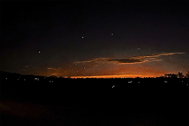 The evening sky and points of light are seen near Lebanon Township, New Jersey, on December 5. The sightings have put intense pressure on federal agencies to provide more information about the aircraft.
Mandatory Credit:	Trisha Bushey/AP via CNN Newsource