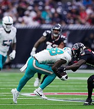 DuBose is brought down by Houston Texans safety Calen Bullock, right, on a play that left DuBose injured.
Mandatory Credit:	Eric Christian Smith/AP via CNN Newsource