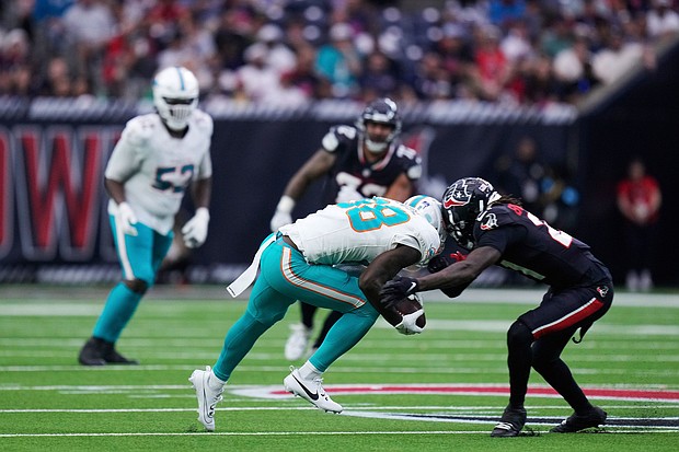 DuBose is brought down by Houston Texans safety Calen Bullock, right, on a play that left DuBose injured.
Mandatory Credit:	Eric Christian Smith/AP via CNN Newsource