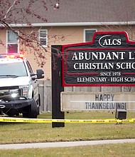 Emergency vehicles are parked outside the Abundant Life Christian School in Madison, Wisconsin, following a shooting on December 16.
Mandatory Credit:	Morry Gash/AP via CNN Newsource