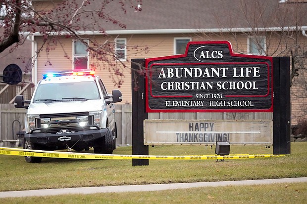 Emergency vehicles are parked outside the Abundant Life Christian School in Madison, Wisconsin, following a shooting on December 16.
Mandatory Credit:	Morry Gash/AP via CNN Newsource