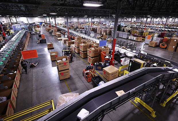 US Postal Service employees work inside the Los Angeles Mail Processing & Distribution Center on December 3. The facility is currently processing 1 million packages per day.
Mandatory Credit:	Mario Tama/Getty Images via CNN Newsource