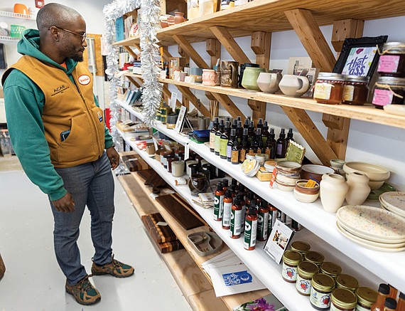 Oliver Saunders shops for gifts at the Bizarre Market at the Visual Arts Center of Richmond, open daily from 11 a.m. to 6 p.m. through Dec. 23, featuring handmade goods by local vendors.