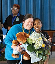 Richmond Public Schools teacher Rebecca McCray, poses with fifth-grader Jha’Ny after being named RPS Teacher of the Year on Dec. 8. The surprise announcement at Oak Grove-Bellemeade Elementary included Superintendent Jason Kamras, School Board members and cheering students and staff.