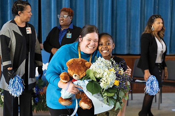 Richmond Public Schools teacher Rebecca McCray, poses with fifth-grader Jha’Ny after being named RPS Teacher of the Year on Dec. 8. The surprise announcement at Oak Grove-Bellemeade Elementary included Superintendent Jason Kamras, School Board members and cheering students and staff.